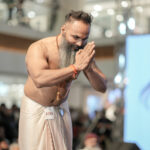 Spiritual performer greeting audience on stage event photography